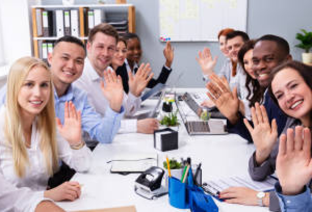 Happy Business Group Of Diverse People Waving Hands During A Meeting Conference In The Office